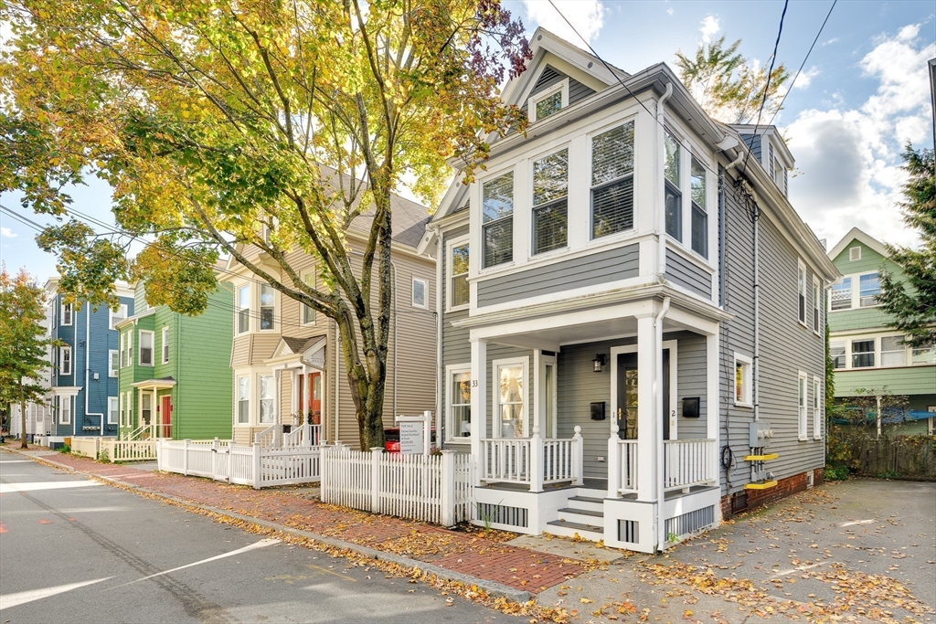 33 Line Street, Unit 1 Cambridge, MA 02138 - Photo 16 of 22 a view of a brick house with large windows and a large tree