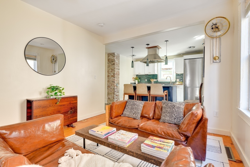 33 Line Street, Unit 1 Cambridge, MA 02138 - Photo 20 of 22 a living room with furniture and a chandelier