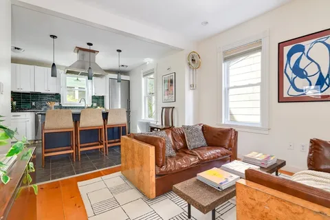a kitchen with granite countertop cabinets stainless steel appliances a sink and a window