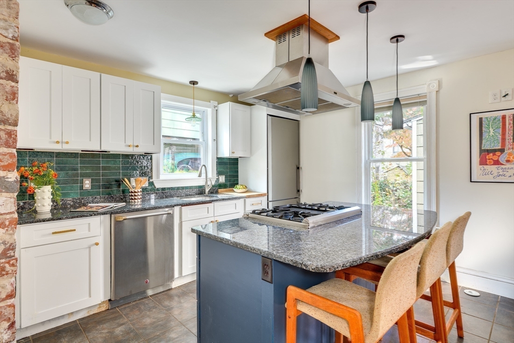 33 Line Street, Unit 1 Cambridge, MA 02138 - Photo 8 of 22 a kitchen with granite countertop cabinets stainless steel appliances a sink and a window