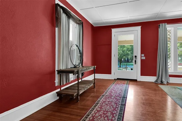 a living room with furniture a fireplace and a floor to ceiling window