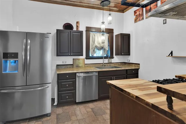 a kitchen with a sink stove and cabinets