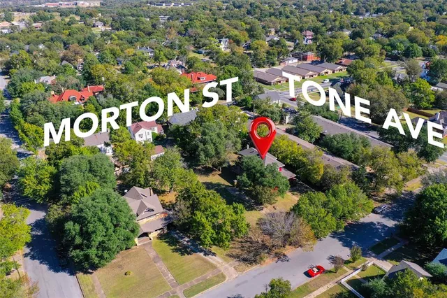 an aerial view of a house with garden space and sitting area