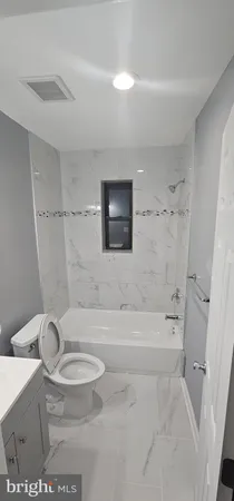 a bathroom with a toilet and a bathtub