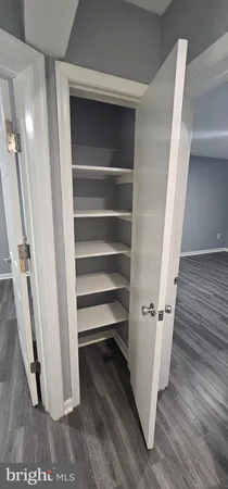 a view of walk in closet with empty racks