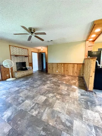 a view of a livingroom with a fireplace and a chandelier