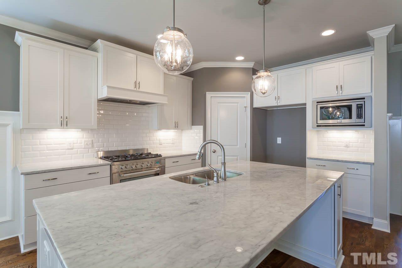 321 Georgetown Road Raleigh, NC 27608 - Photo 9 of 25 a kitchen with stainless steel appliances granite countertop a sink a stove and a refrigerator
