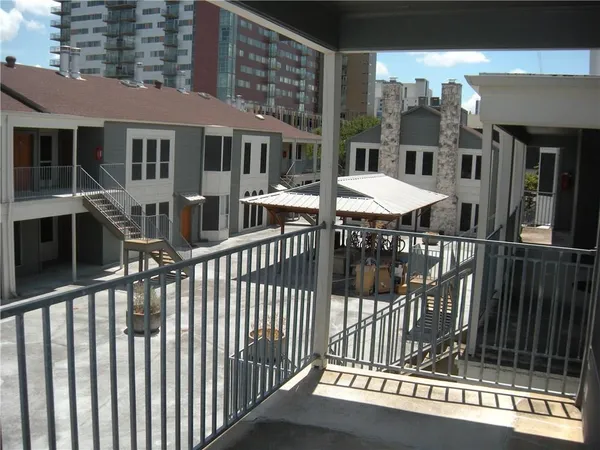 a view of a house with a wooden deck