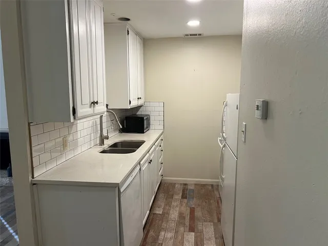 a kitchen with a sink and a stove top oven