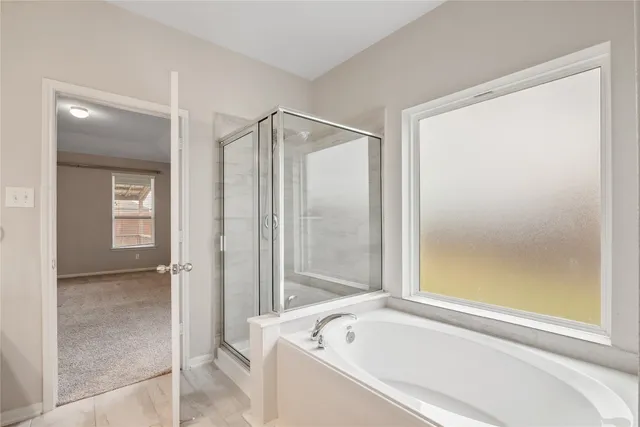 a bathroom with a bathtub and a shower