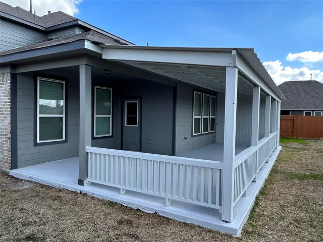 a view of a house with wooden fence