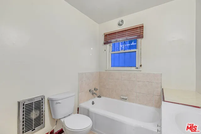 a bathroom with a shower and a sink