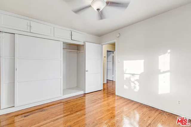 a balcony with couch and wooden floor