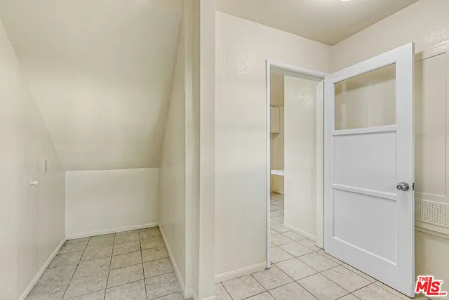 a spacious bathroom with a granite countertop sink and a mirror