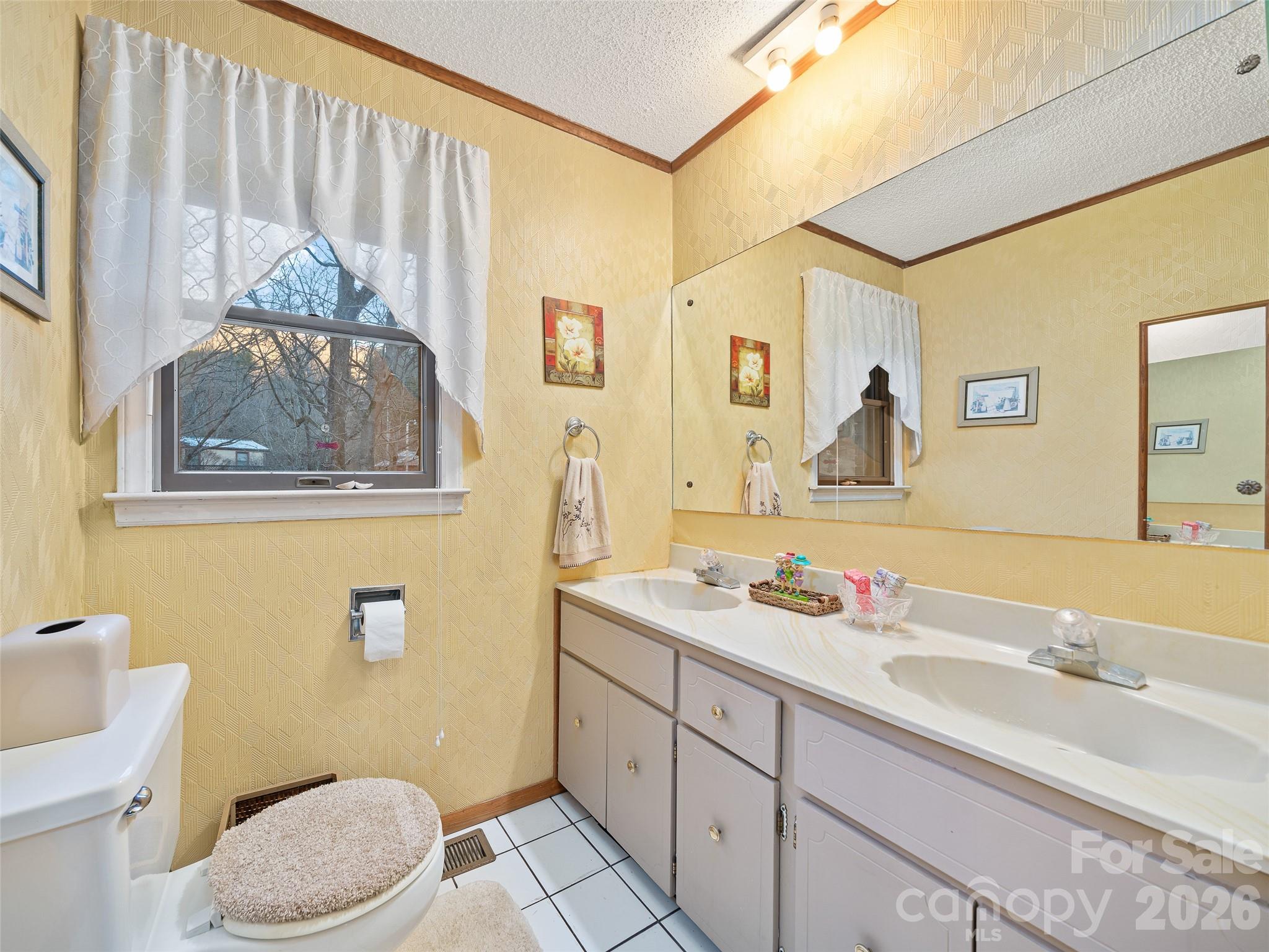 1280 Hamburg Road Bakersville, NC 28705 - Photo 13 of 28 a bathroom with a sink a mirror a toilet and a shower