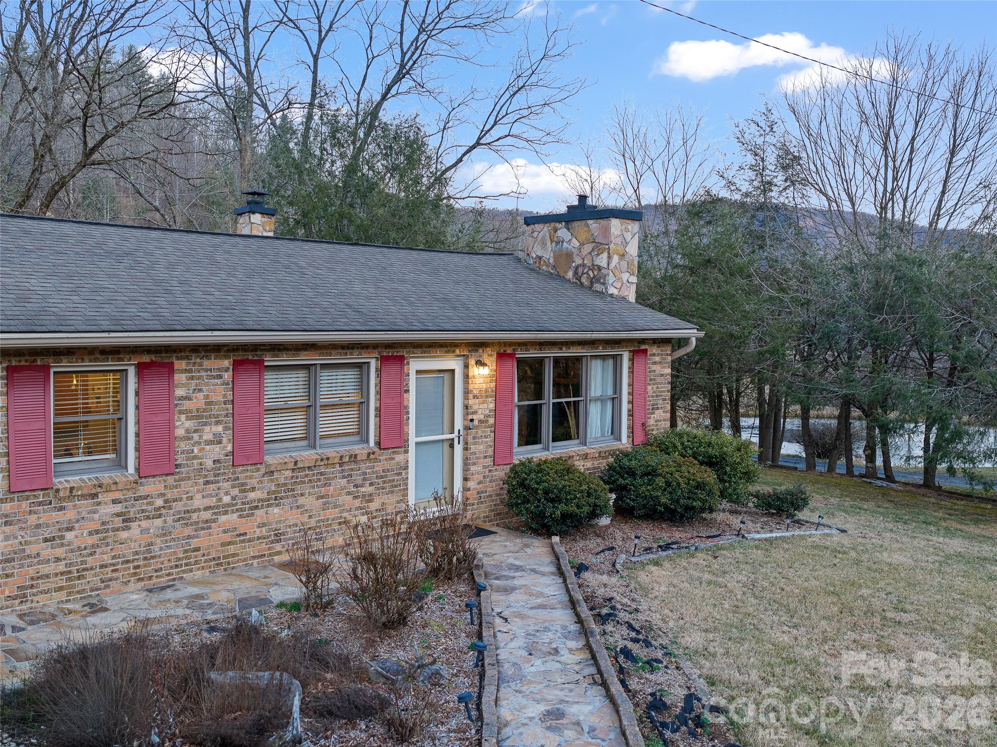 1280 Hamburg Road Bakersville, NC 28705 - Photo 2 of 28 a front view of a house with garden