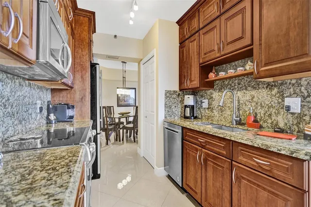 a kitchen with granite countertop lots of counter top space and windows