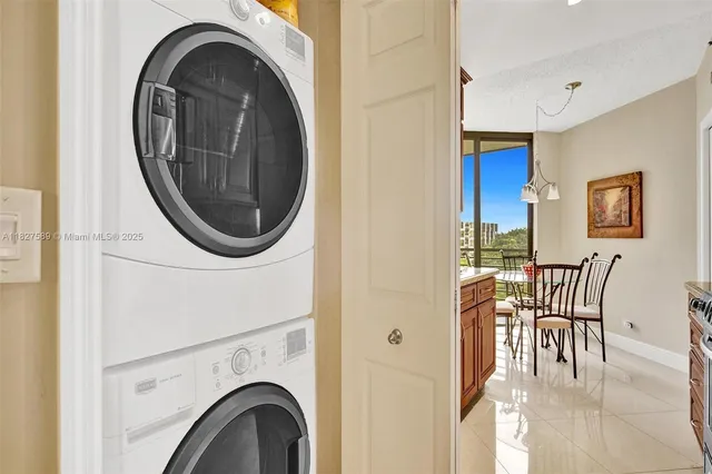 a view of a livingroom with furniture staircase and a chandelier