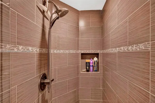 a bedroom with a bed and a dresser next to a window