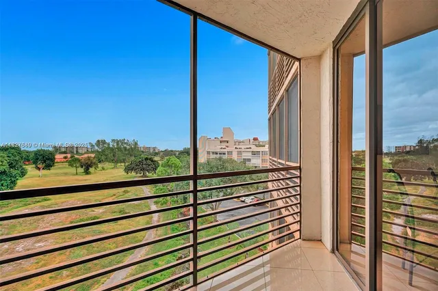 a view of a balcony next to a yard