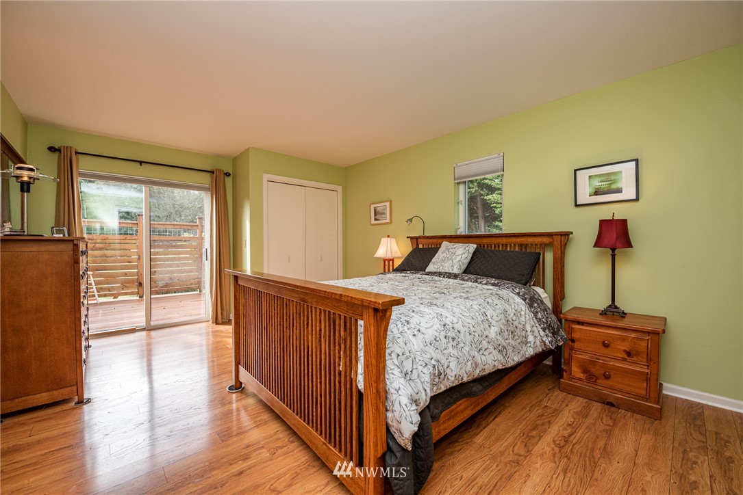 481 Holgerson Road Sequim, WA 98382 - Photo 13 of 40 a bedroom with a bed and wooden floor