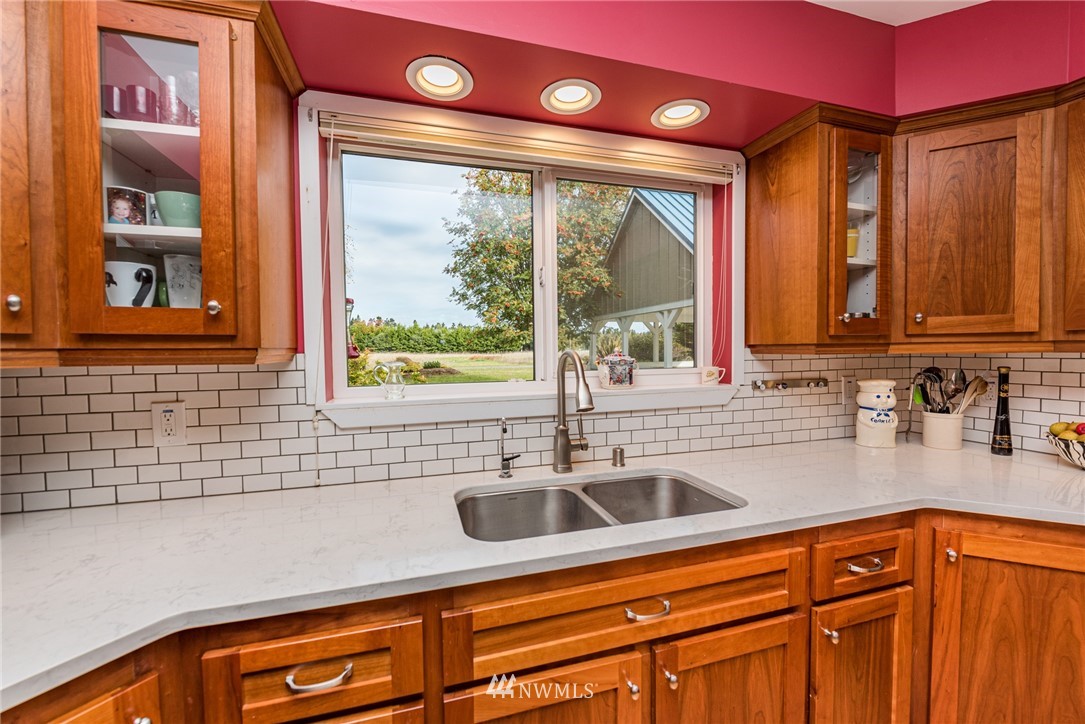 481 Holgerson Road Sequim, WA 98382 - Photo 16 of 40 a kitchen with stainless steel appliances a sink a stove and a window