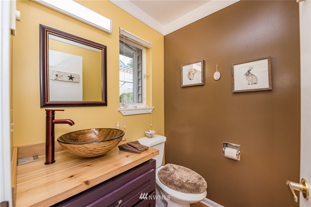 481 Holgerson Road Sequim, WA 98382 - Photo 24 of 40 a bathroom with a granite countertop toilet sink and mirror