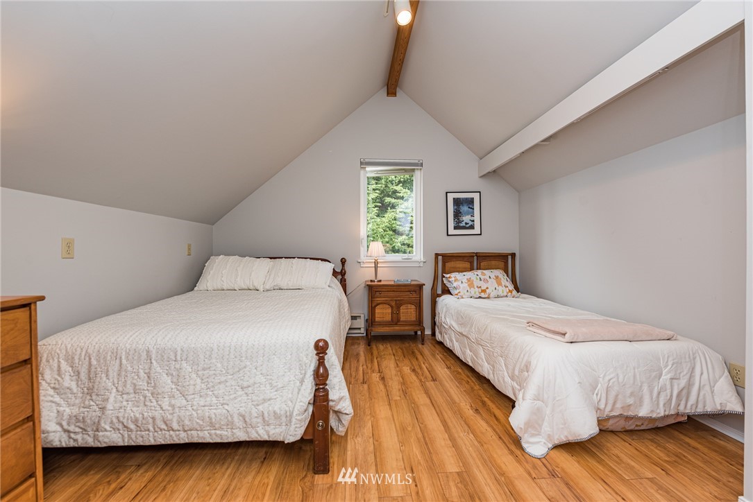 481 Holgerson Road Sequim, WA 98382 - Photo 29 of 40 a bedroom with a bed and wooden floor