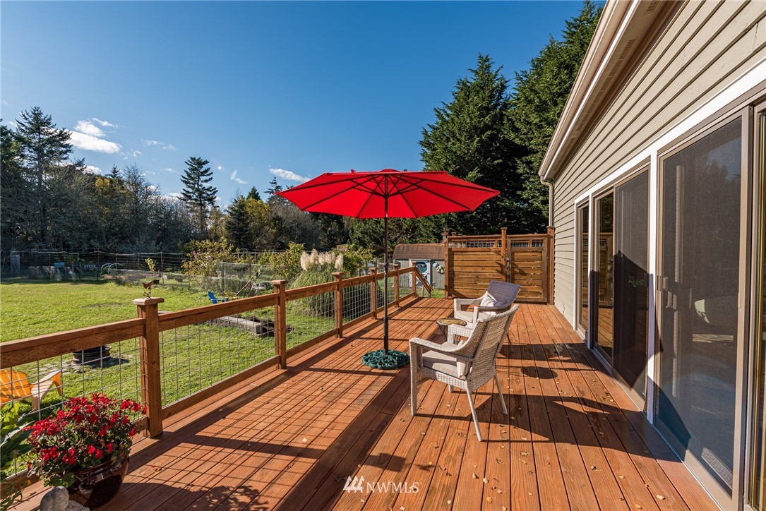 481 Holgerson Road Sequim, WA 98382 - Photo 33 of 40 a view of a balcony with chairs and wooden floor