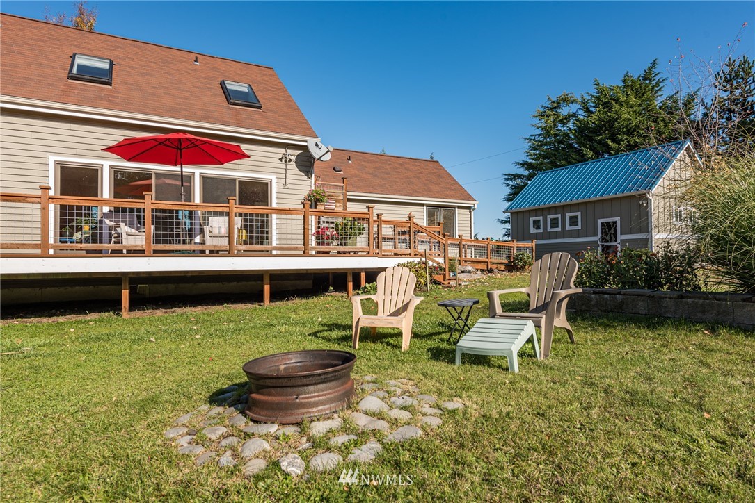 481 Holgerson Road Sequim, WA 98382 - Photo 38 of 40 a backyard of a house with yard and outdoor seating