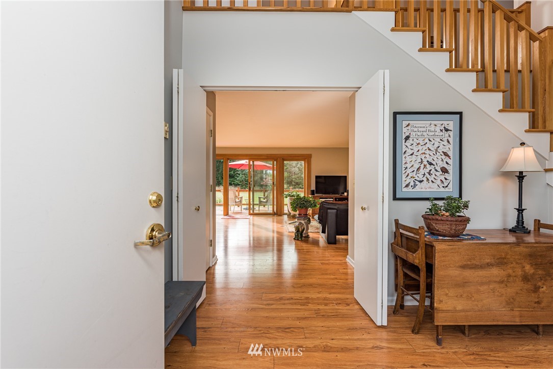 481 Holgerson Road Sequim, WA 98382 - Photo 8 of 40 a hallway with a table and a chairs