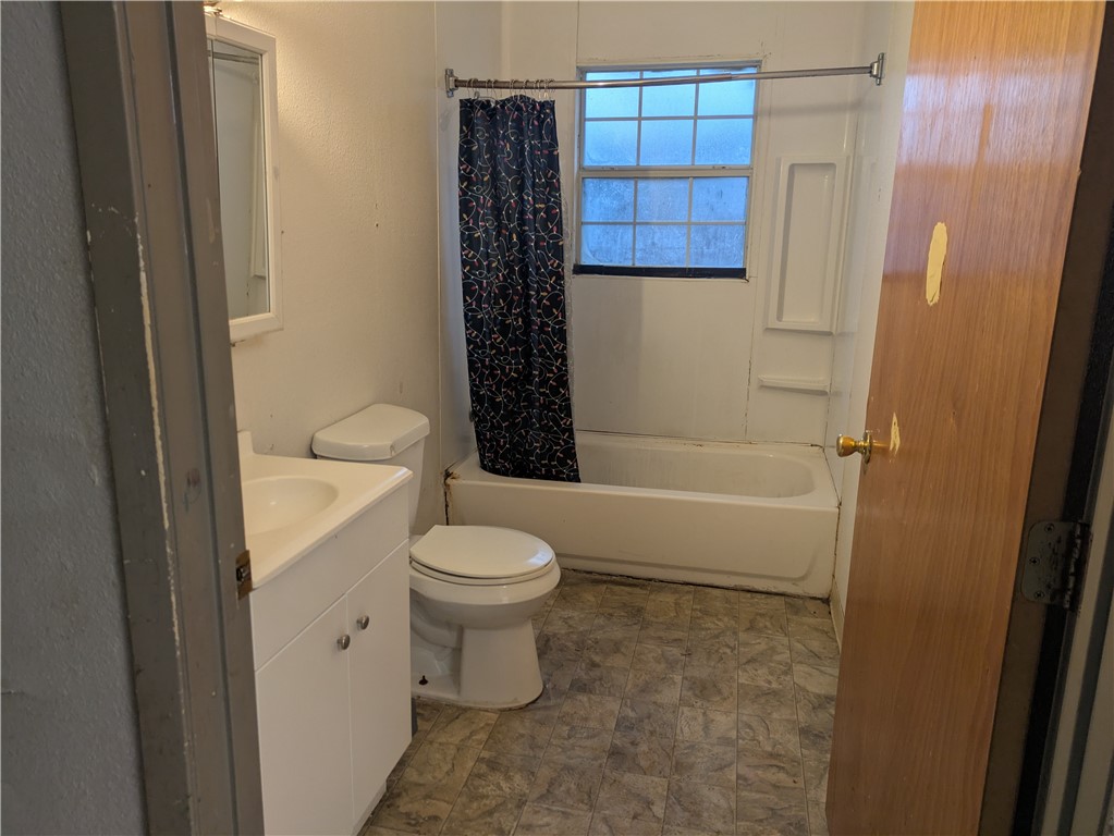 822 Olivo Street Mathis, TX 78368 - Photo 6 of 7 a bathroom with a toilet and a shower