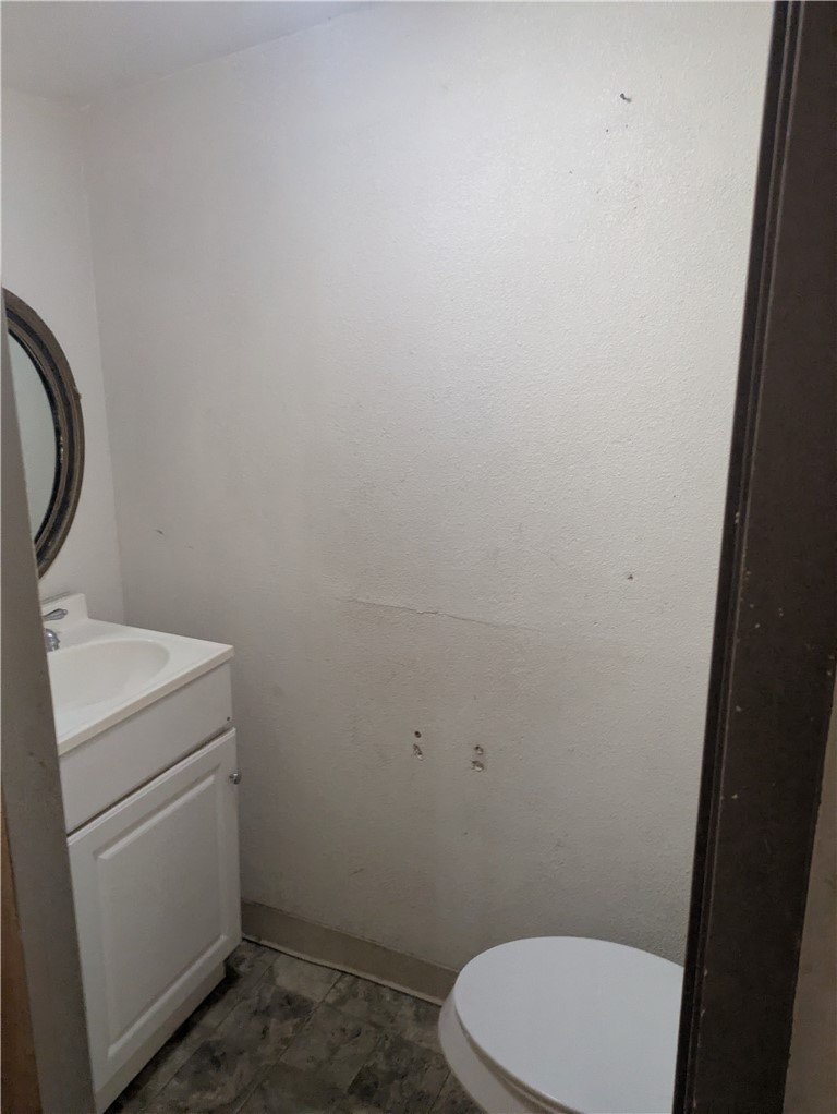 822 Olivo Street Mathis, TX 78368 - Photo 7 of 7 a bathroom with a toilet and a sink