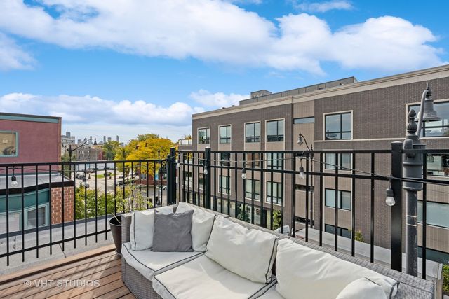 a roof deck with table and chairs