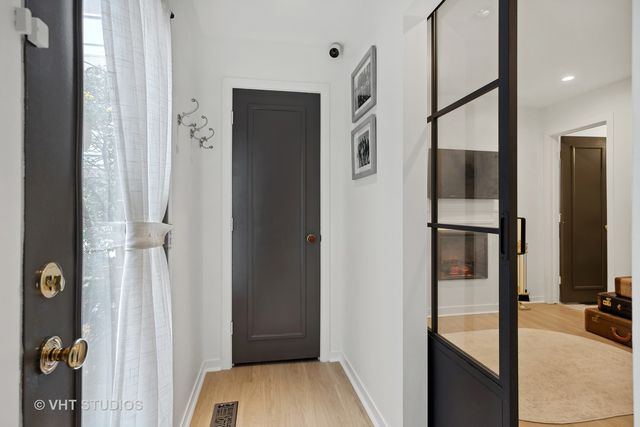 a view of hallway with wooden floor