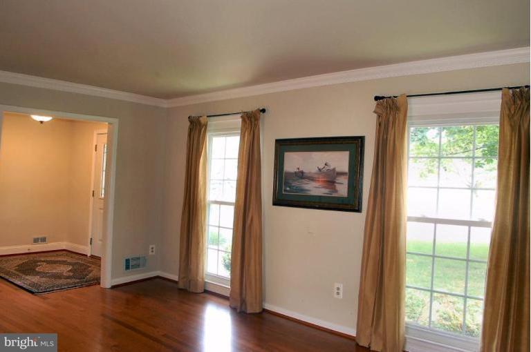 14200 Ansted Road Silver Spring, MD 20905 - Photo 14 of 30 a view of an empty room with wooden floor and a window