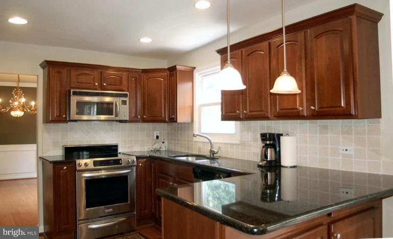 14200 Ansted Road Silver Spring, MD 20905 - Photo 3 of 30 a kitchen that has a sink and a stove in it