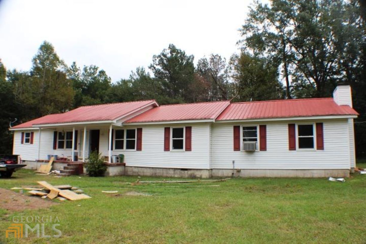 954 Evergreen Road Dublin, GA 31021 - Photo 1 of 1 a front view of a house with a garden