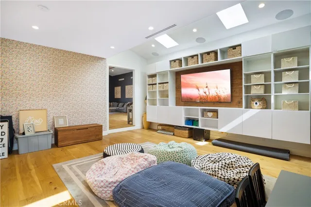 a living room with furniture rug and wooden floor