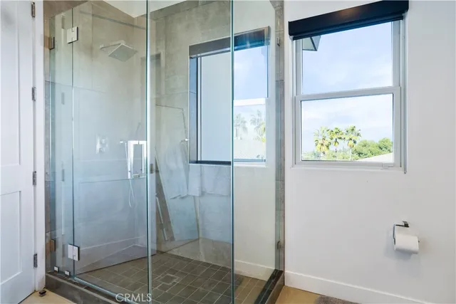 a bedroom with a large bed and a balcony