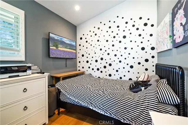 a bedroom with a large bed and a chandelier