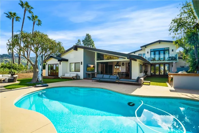 an aerial view of a house with swimming pool garden and patio