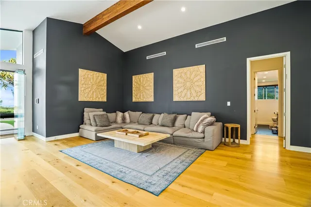 a living room with furniture and kitchen view