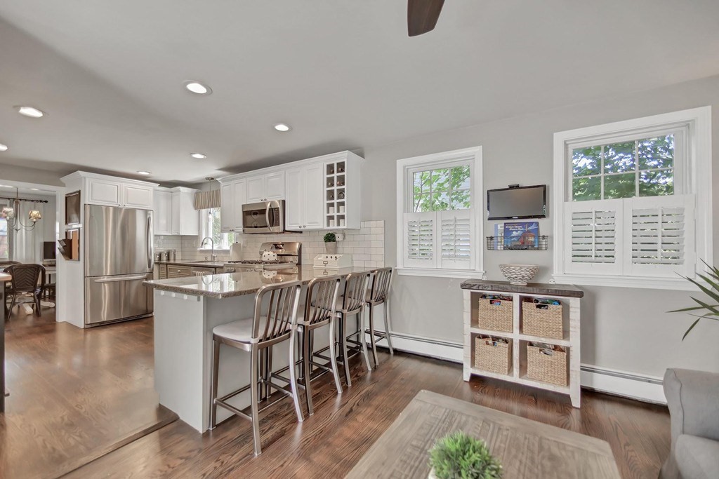 5 Magnolia Road Milton, MA 02186 - Photo 7 of 26 a kitchen with kitchen island a large window and cabinets