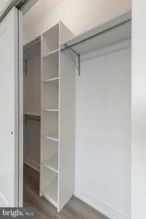 a view of walk in closet with empty racks