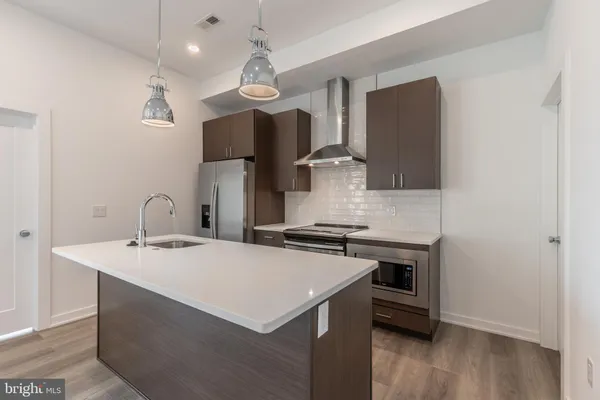 a kitchen with stainless steel appliances a sink and a stove