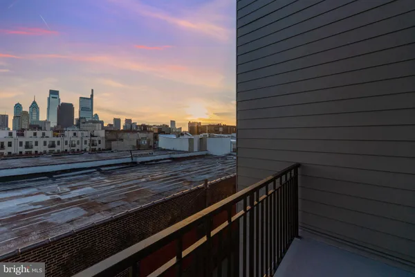 a view of a balcony with wooden floor and city view