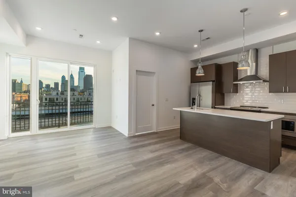 a large kitchen with a refrigerator and a sink