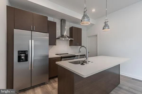 a kitchen with kitchen island a sink appliances and cabinets