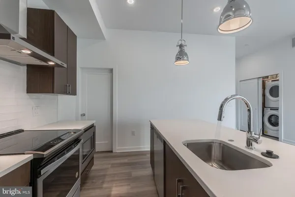 a kitchen with stainless steel appliances granite countertop a sink and a stove